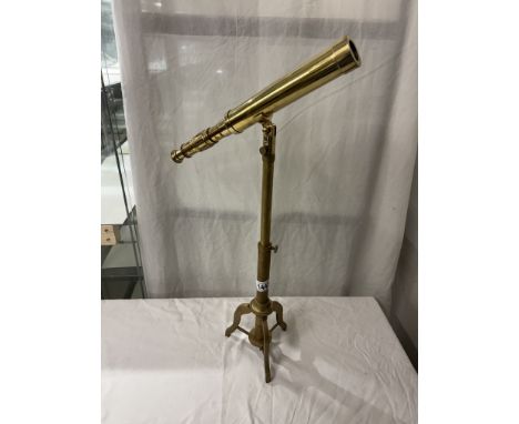 A brass telescope on tripod base