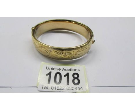 An engraved bangle marked 1/5 9ct M/C S &amp; K.