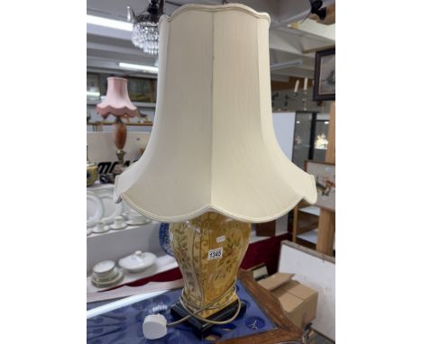 A pottery table lamp with shade.