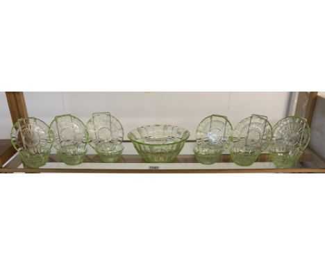 A vintage set of uranium glass fruit bowl with 6 matching dishes &amp; 6 saucers