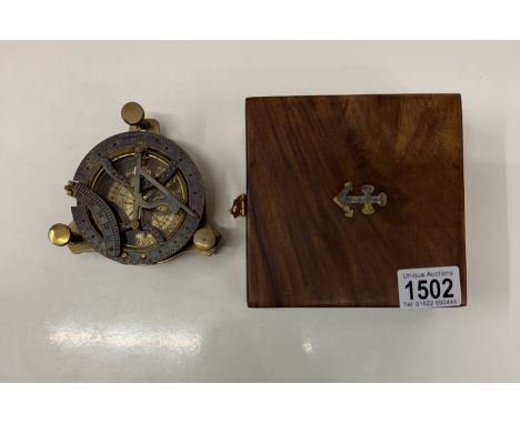 A brass multi sextant / sundial in brass bound teak box