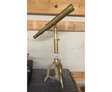 A brass telescope on tripod base