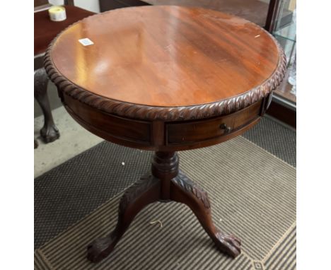A mahogany drum table on tripod base.
