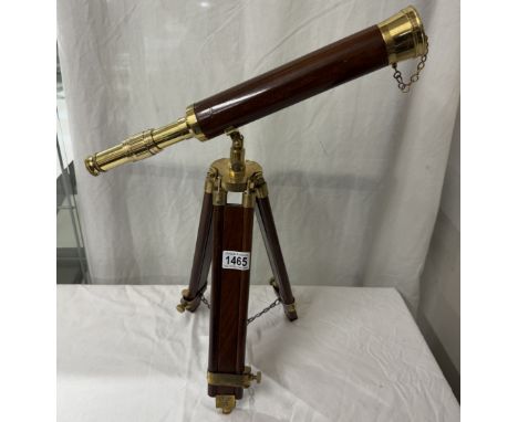 A brass telescope with wooden barrel on tripod base. Length 43cm