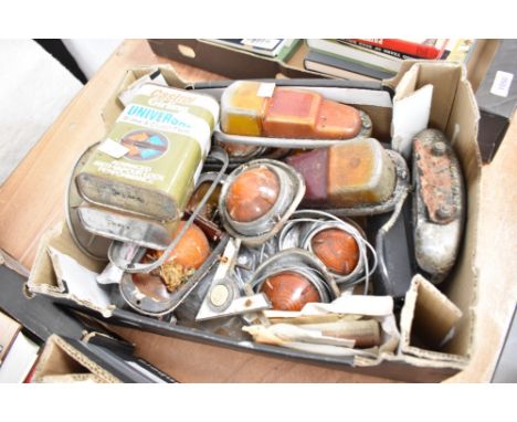 A box of vintage light fittings, badges etc