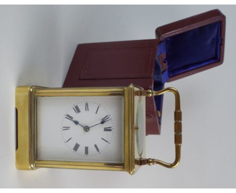 A late 19th century brass carriage clock, the 2½ inch enamel dial with ring of Roman numerals, the eight day spring driven mo