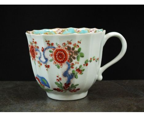 A Worcester Kakiemon fluted coffee cup, circa 1760, painted with Two Quails, flowering prunus and insects, within a turquiose
