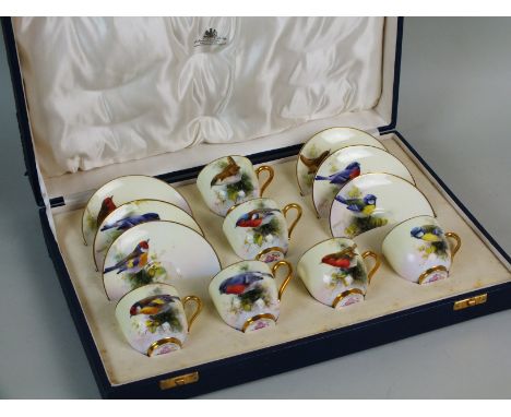 A Royal Worcester porcelain coffee service by Ernest Barker, dated 1935, comprising six cups, and six saucers, each piece ind