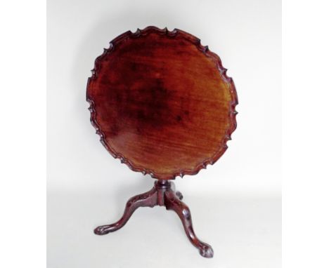 An 18th century and later mahogany Chippendale style tilt top pedestal supper table on tripod base, terminating in ball and c