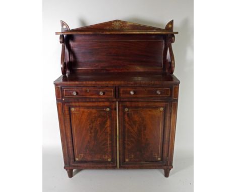 A Regency rosewood brass line strung two door chiffonier with pointed arch back and open shelf over two short frieze drawers 