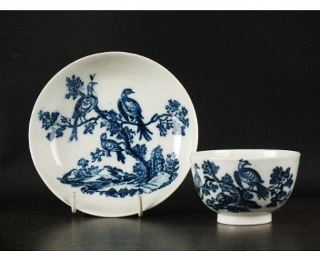 A Caughley tea bowl and saucer, circa 1785, transfer-printed in underglaze blue with the Birds in Branches pattern, tea bowl 