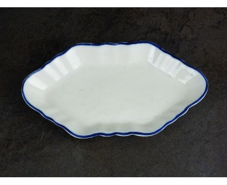 A Caughley spoon tray, circa 1780, the plain elongated hexagonal form with single blue line border, unglazed base with painte