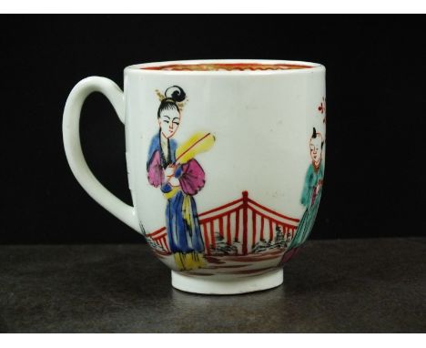 A Worcester polychrome coffee cup, circa 1765, painted with Chinoiserie figures, with a Kangxi fence to the rear, with intern