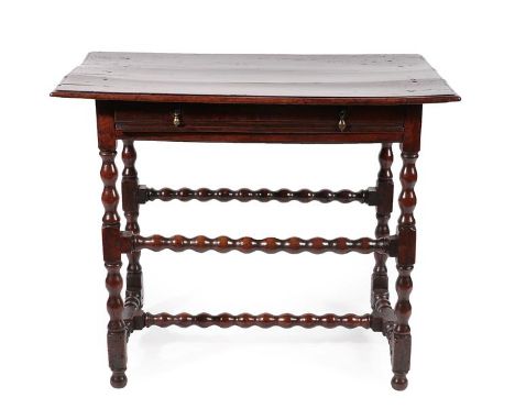 A Mid 17th Century Walnut Side Table, the three-plank top with moulded edge above a moulded frieze drawer, on bobbin and bloc