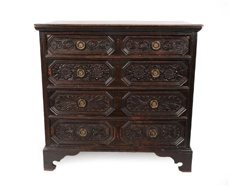 A 17th Century Oak Straight Front Chest of Drawers, the moulded top above four geometric moulded drawers with later carving, 