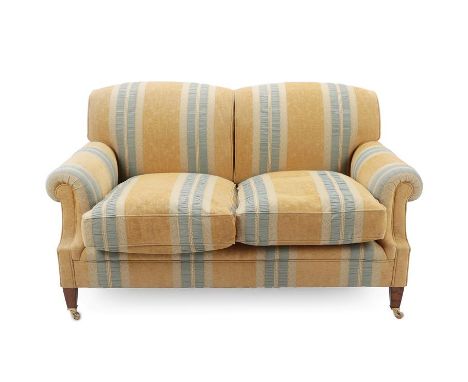 George Smith Ltd: A Victorian Style Two-Seater Sofa, circa 2004, covered in yellow and pale green stripped fabric, with round