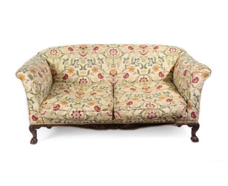 A Carved Mahogany Two-Seater Sofa, late 19th/early 20th century, recovered in modern crewelwork style fabric, with overstuffe