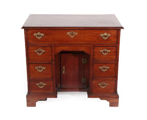 A George III Mahogany Kneehole Desk, 3rd quarter 18th century, the moulded top above a long frieze drawer with fall front enc