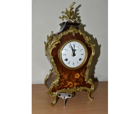 A REPRODUCTION FRENCH STYLE MANTEL CLOCK, with a bell striking German mechanism, enamel dial and painted Roman numerals, gilt