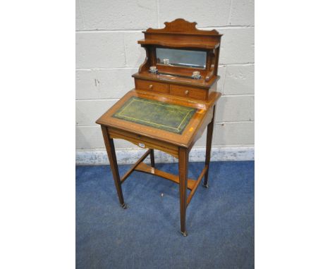 AN EDWARDIAN MAHOGANY LADIES WRITING DESK, the raised back with a bevelled mirror plate, two glass ink wells, a pen tidy, two