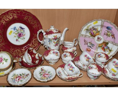 A COLLECTION OF NAMED PORCELAIN TEAWARE, comprising a Royal Worcester service plate with a wide red border and cream ground c