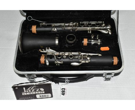 A 'JAZZ ACOUSTIC' CLARINET, comprising a cased hard rubber body professional clarinet, seventeen keys, tone Bb, including har