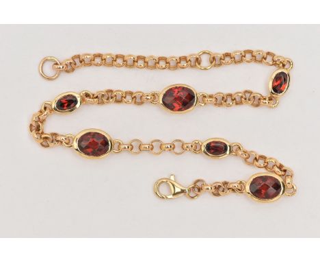 A MODERN YELLOW METAL BRACELET, a belcher link style station bracelet, bezel set with six oval cut garnets, fitted with a lob