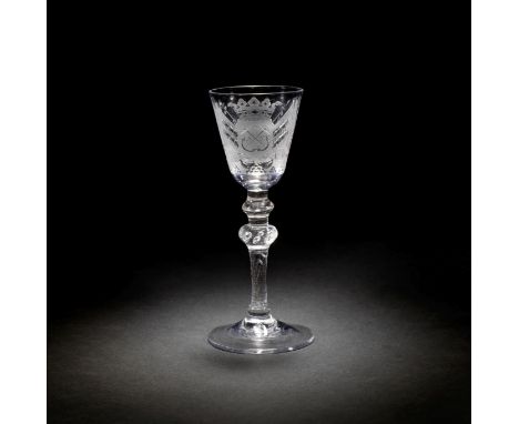 A fine Dutch engraved armorial light baluster wine glass attributed to Jacob Sang, circa 1760The round funnel bowl finely dec