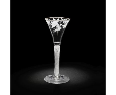 A Beilby enamelled opaque twist wine glass, circa 1765-70The flared trumpet bowl painted in opaque white with a band of fruit