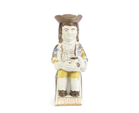A rare Prattware 'Thin Boy' Toby Jug, circa 1790-1800Modelled seated on a neat rectangular base with a fluted panel at the fr