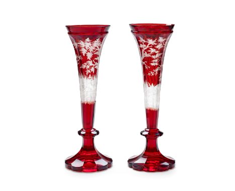 A pair of Bohemian ruby-stained vases, circa 1850-60The tall, broad-fluted trumpet bowls deeply carved through to the clear g