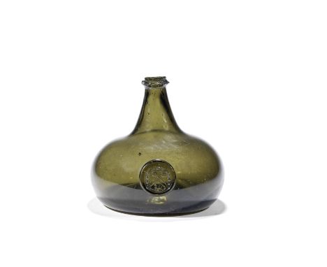 A rare sealed armorial wine bottle, circa 1710-15Of 'Onion' form in olive-green glass, the large bulbous body with a short ta