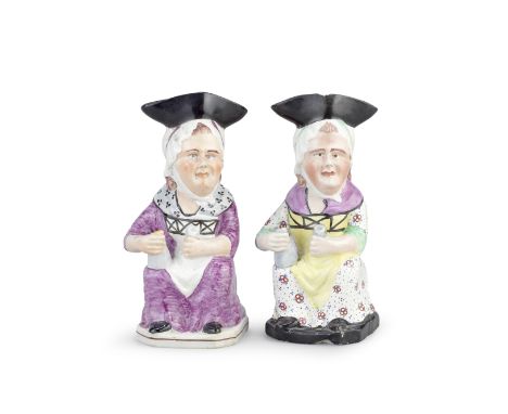 Two Staffordshire 'Martha Gunn' Toby Jugs, circa 1810-20Modelled seated and holding a foaming jug and a cup, their black hats