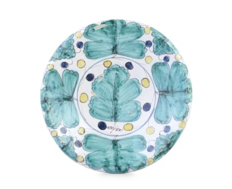 An English delftware 'Oak Leaf' charger, circa 1690Boldly painted with a central leaf and four other leaves around the border