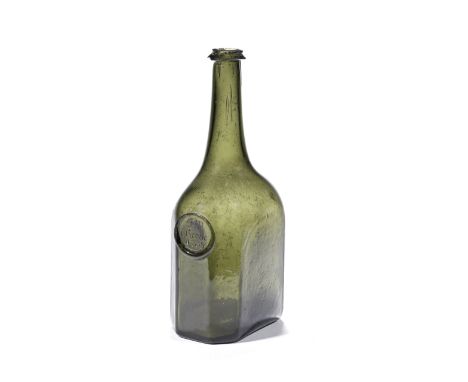 A very rare octagonal sealed wine bottle, dated 1738Of 'Rectangular Octagonal Cylinder' form in olive-green glass, the long t