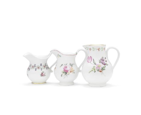 Three Derby creamjugs, circa 1780One of ewer shape in the French taste painted with a delicate border of roses and forget-me-