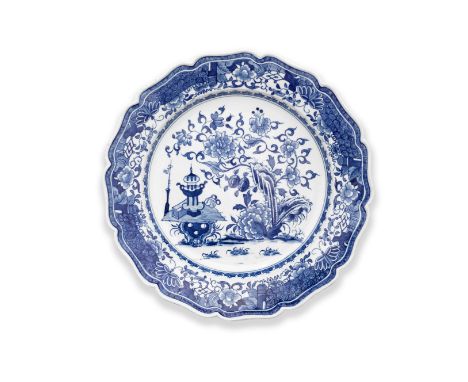 A fine Worcester plate, circa 1772-75Moulded with a twelve-lobed rim after Meissen, finely painted in blue with the 'Garden T
