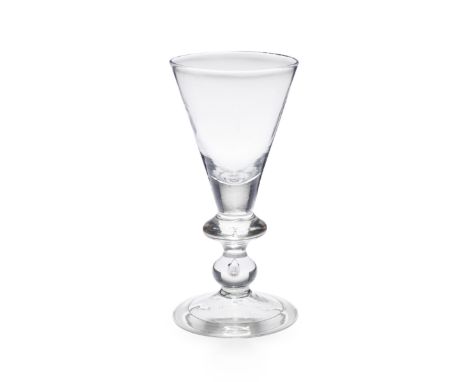 A good heavy baluster goblet, circa 1710The conical bowl solid at the base, on a stem with a wide angular knop with a small c