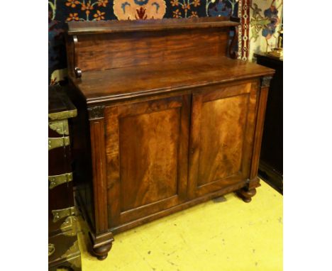 CHIFFONIER, George IV mahogany with raised superstructure over a pair of panelled doors flanked by fluted columns and carved 