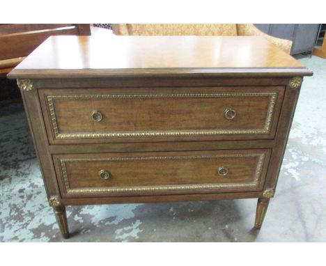 COMMODE, Louis XVI style in a walnut finish with two drawers below and gilt carved detail, 109cm W x 80cm H x 52cm D.