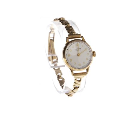 LADY'S VERTEX REVUE NINE CARAT GOLD MANUAL WIND WRIST WATCHthe round white dial with Arabic numerals in gold, outer seconds t