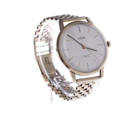 GENTLEMAN'S HEFIK NINE CARAT GOLD MANUAL WIND WRIST WATCHthe round white dial with applied gold baton hour markers, 32mm case