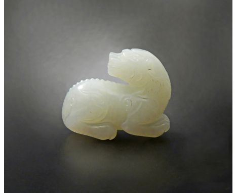 A SMALL CHINESE WHITE JADE CARVING OF A KYLIN QING DYNASTY OR LATER In a recumbent position, its head turned over its back, t