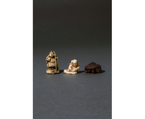 THREE JAPANESE NETSUKE 19TH CENTURY Two in ivory, the first carved as a man holding a bowl and wearing a demon mask sideways,