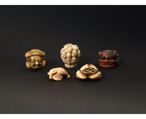 FOUR JAPANESE NETSUKE AND A CANE HANDLE MEIJI 1868-1912 Three of the netsuke in ivory, carved as a cat with an awabi shell, a