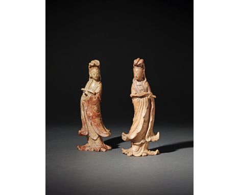 A PAIR OF CHINESE SOAPSTONE CARVINGS OF GUANYIN 19TH CENTURY Each wearing billowing robes, decorated with clouds and wave bor