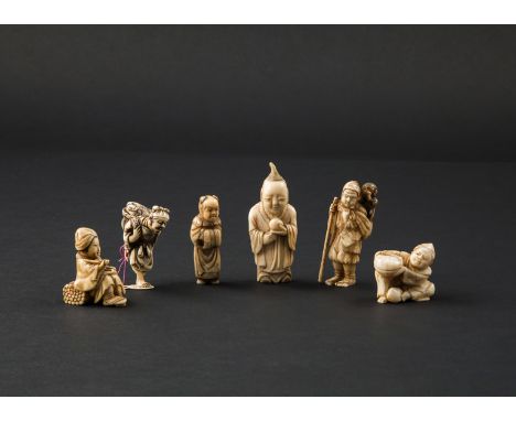 FIVE JAPANESE IVORY NETSUKE MEIJI 1868-1912 Variously carved as a sarumawashi with a monkey on his shoulder, a Chinese boy, a