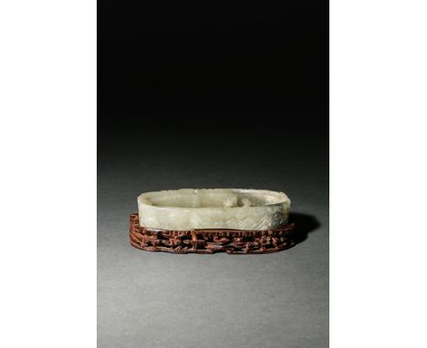 A CHINESE CELADON JADE BRUSH WASHER, 18TH CENTURY Of oval form, the exterior carved as rocks, with two lingzhi fungi emerging