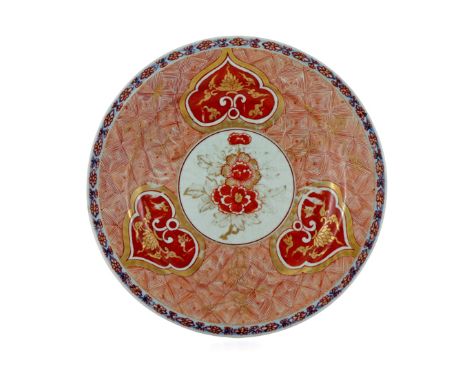 A CHINESE PLATE KANGXI 1662-1722 Enamelled in England c.1760-70 in the Imari manner in iron-red and gilt with three ogee-peta