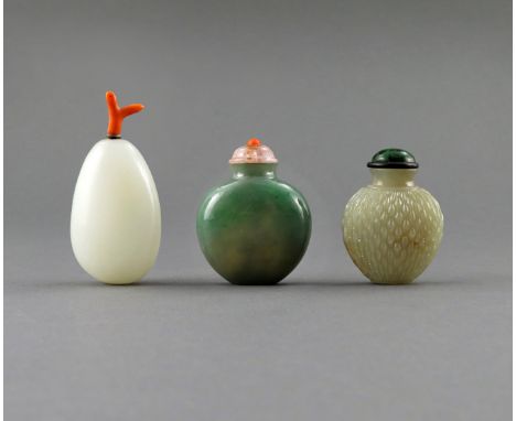 † λ THREE CHINESE JADE SNUFF BOTTLES, 18TH/19TH CENTURY One a white jade pebble with a coral stopper, another jadeite, of pla